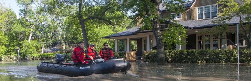 A rescue boat travels down a residential street during the 2013 Calgary Flood